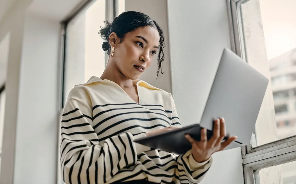 Woman holding her laptop